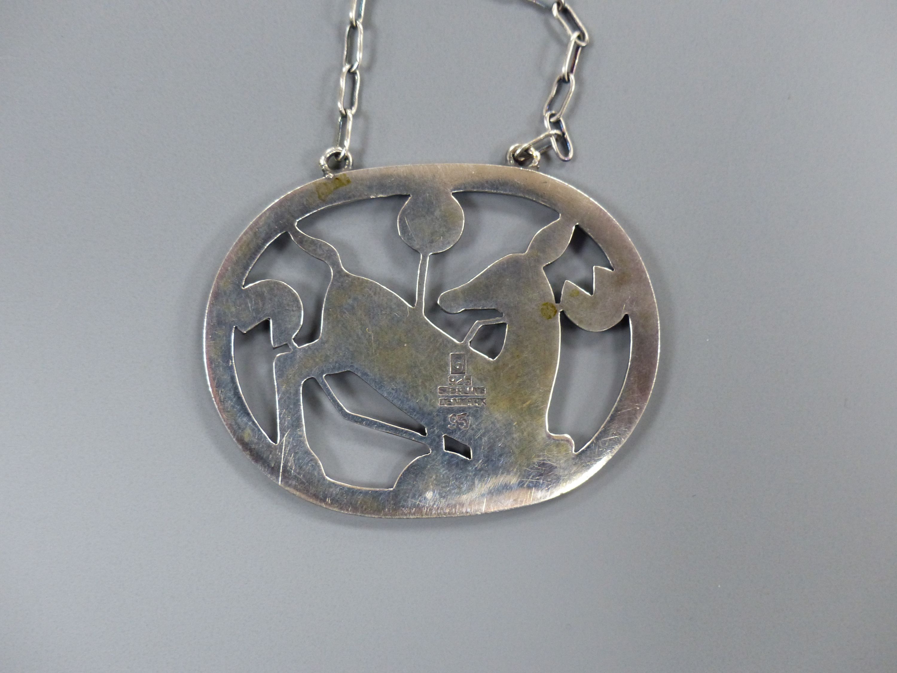 A Georg Jensen sterling oval kneeling deer pendant necklace, no. 95, pendant 42mm, chain, 58cm.